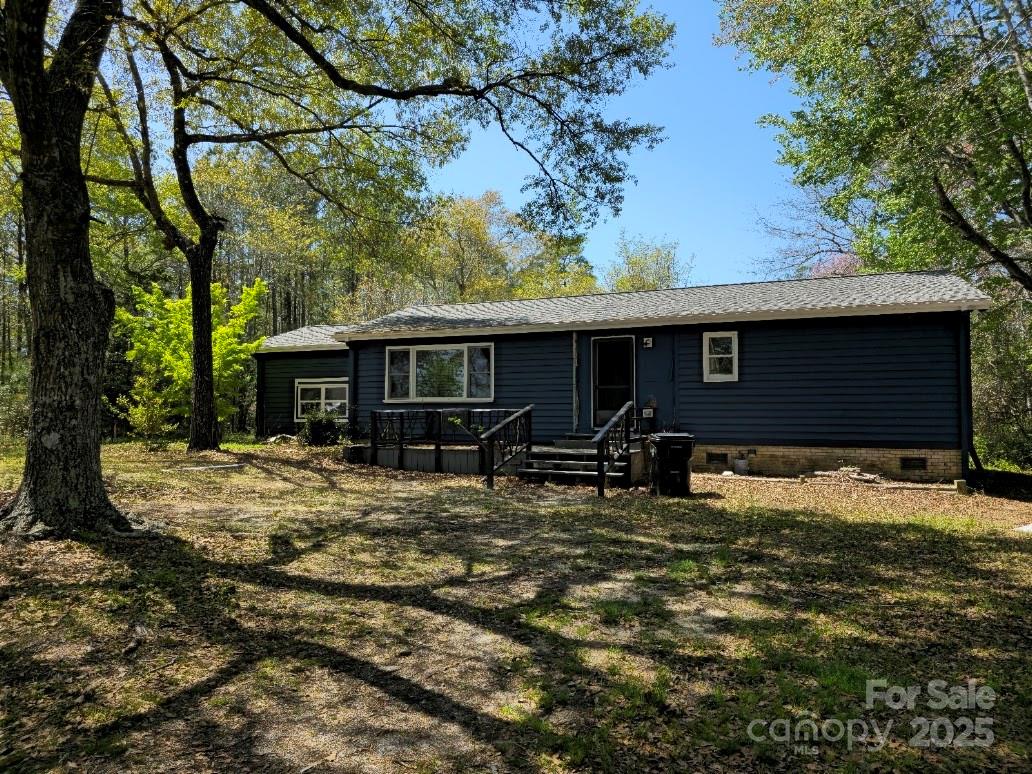 a view of house with backyard and seating space