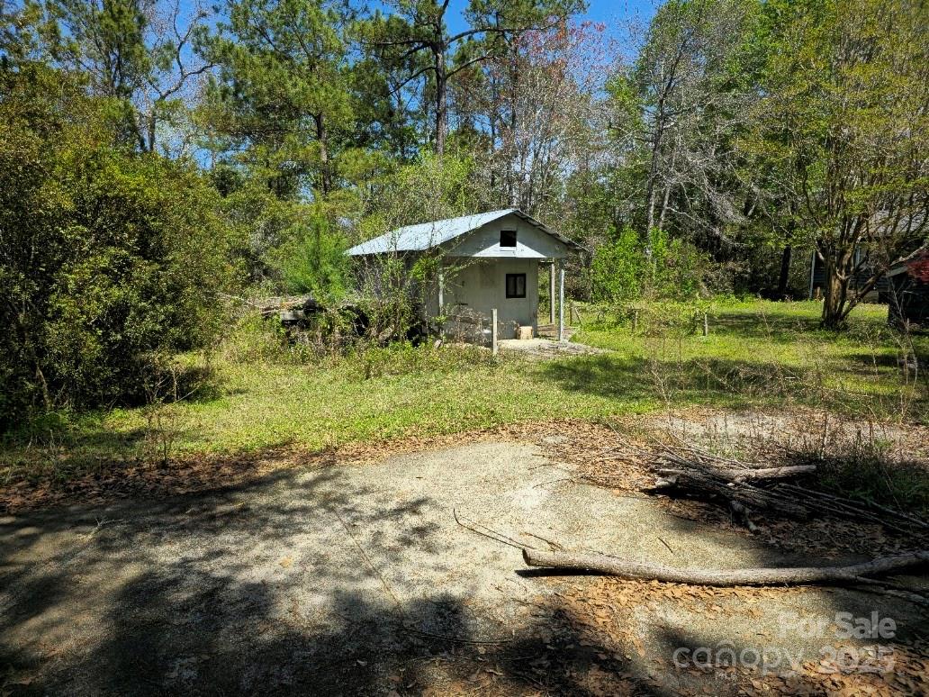 2169 Stone Chimney Road Southwest Supply, NC 28462 - Photo 12 of 27 a view of a garden with a bench and trees