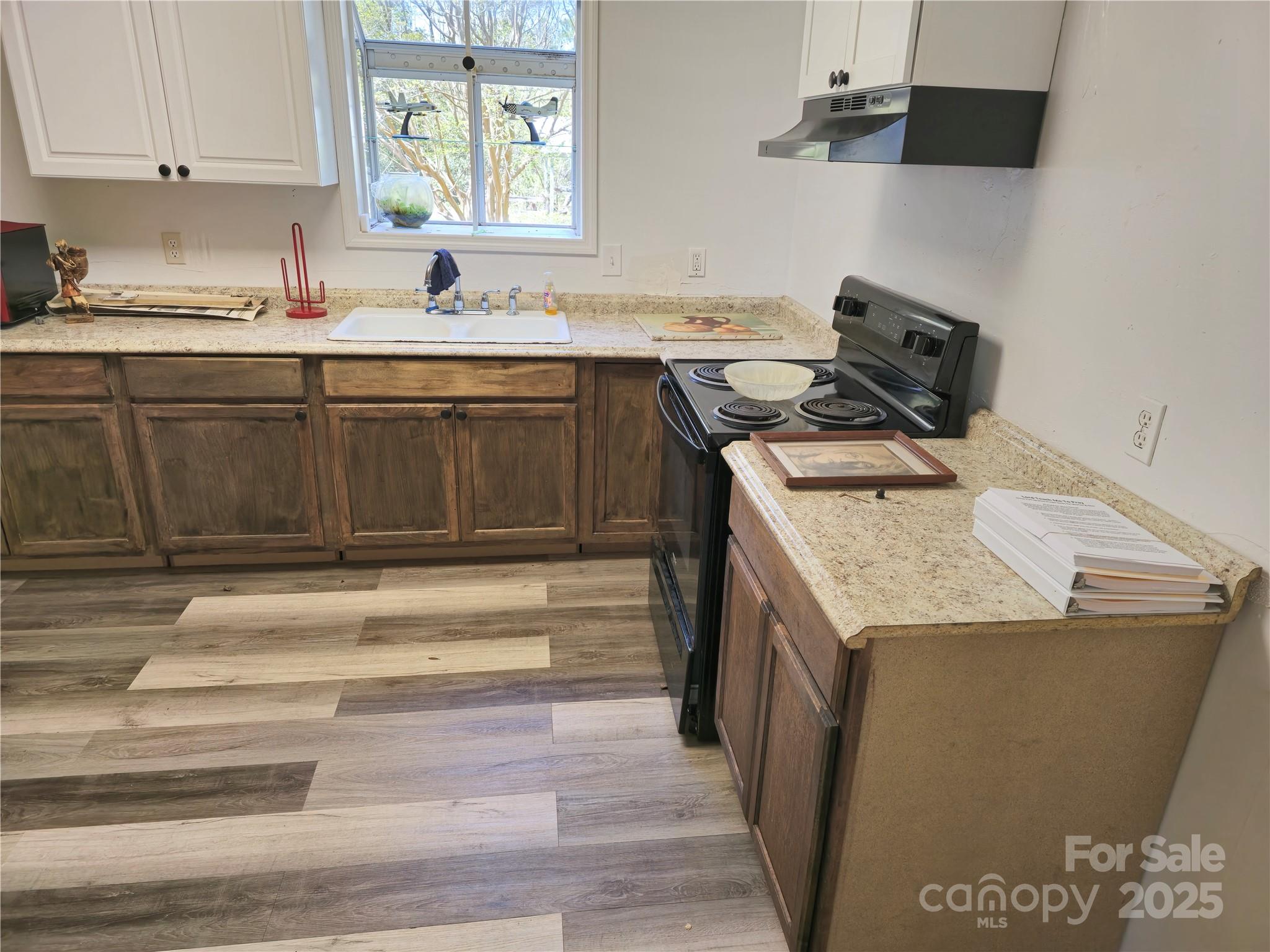 2169 Stone Chimney Road Southwest Supply, NC 28462 - Photo 16 of 27 a kitchen with a stove and a sink