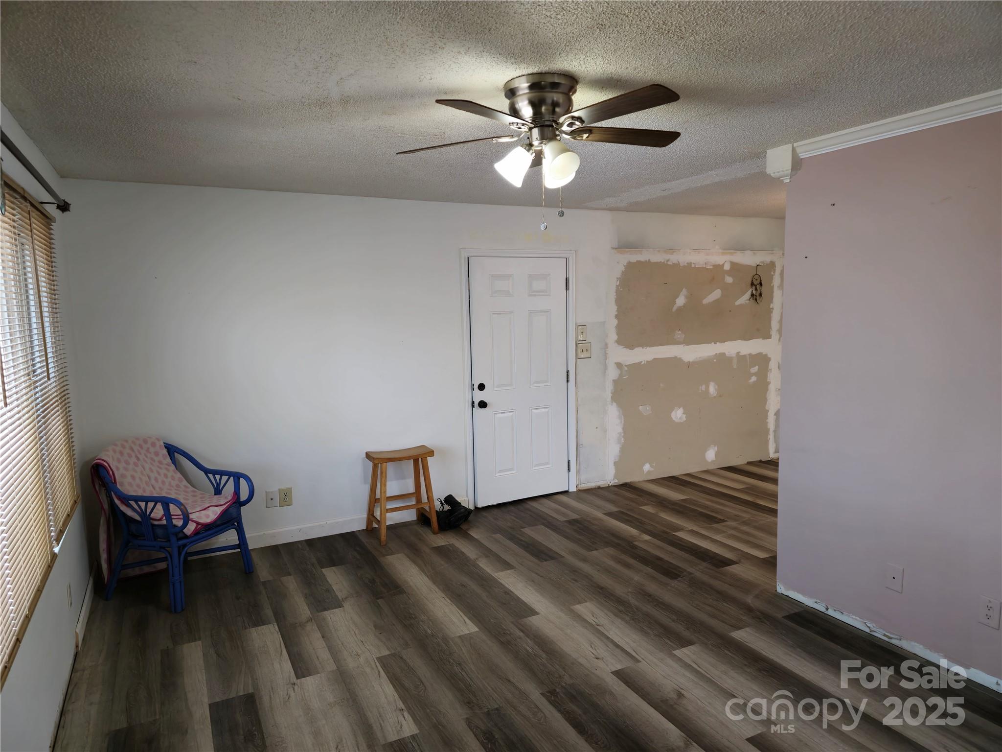 2169 Stone Chimney Road Southwest Supply, NC 28462 - Photo 18 of 27 a view of a livingroom with lounge chair and a ceiling fan
