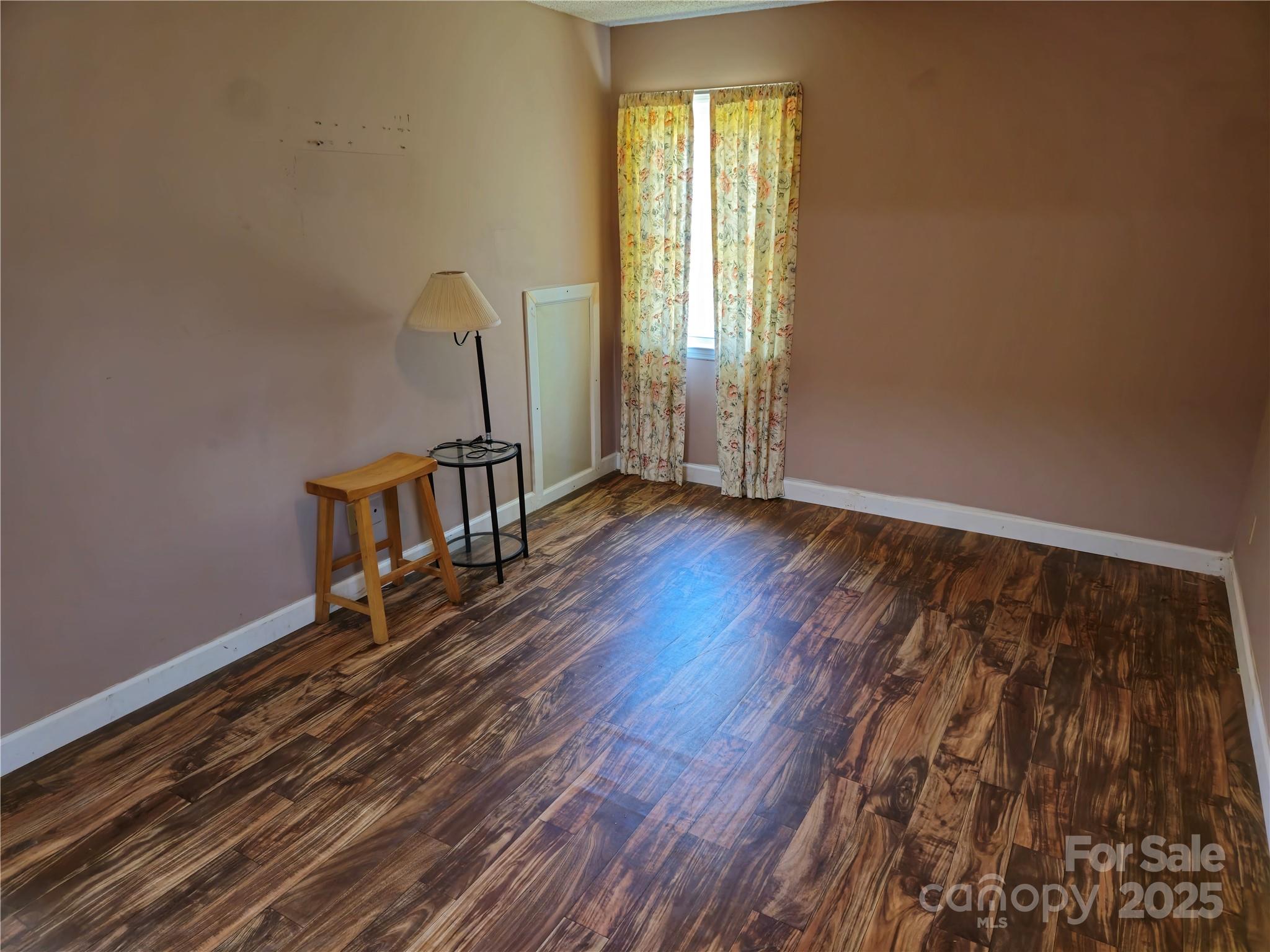 2169 Stone Chimney Road Southwest Supply, NC 28462 - Photo 23 of 27 a view of an empty room with window and wooden floor