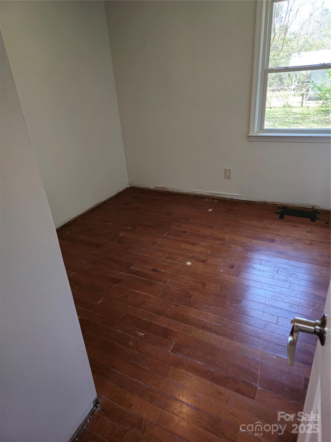 2169 Stone Chimney Road Southwest Supply, NC 28462 - Photo 26 of 27 an empty room with wooden floor and windows