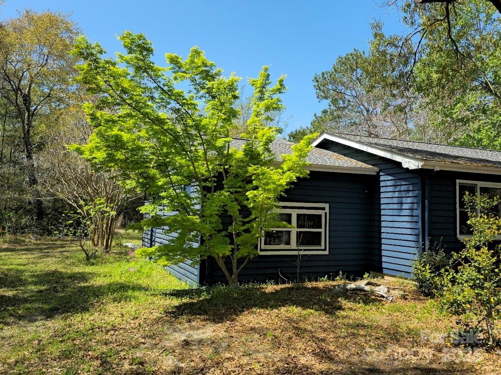 2169 Stone Chimney Road Southwest Supply, NC 28462 - Photo 5 of 27 a backyard of a house with a garden