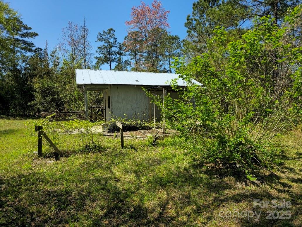 2169 Stone Chimney Road Southwest Supply, NC 28462 - Photo 8 of 27 a backyard of a house with table and chairs