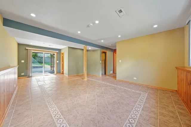 a view of an empty room with glass door