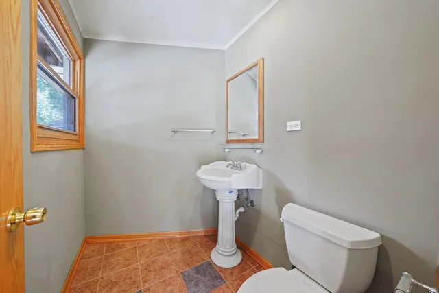 a bathroom with a sink toilet and a mirror