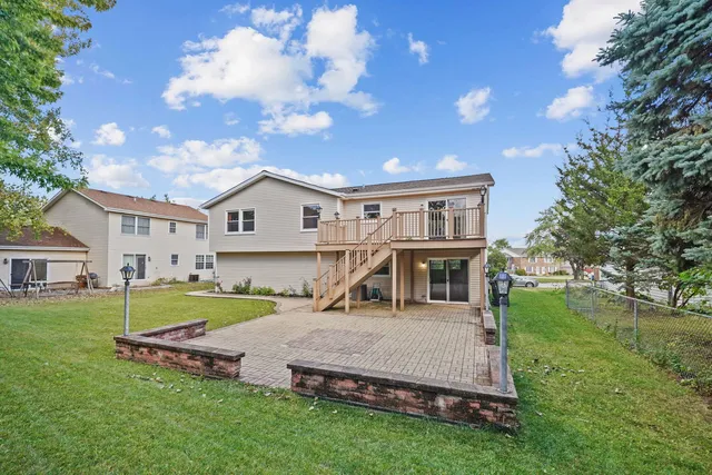 a view of a house with a big yard and large trees