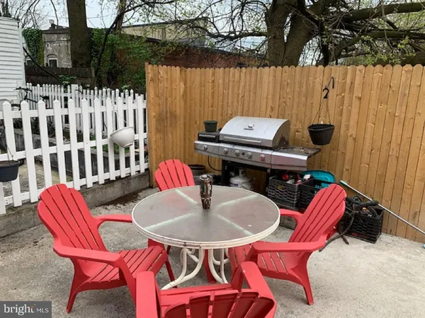a backyard of a house with table and chairs