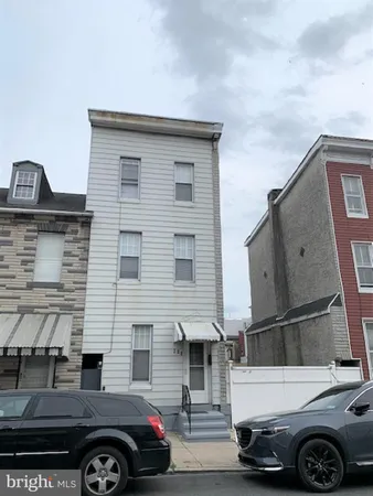 a front view of a house with parking space