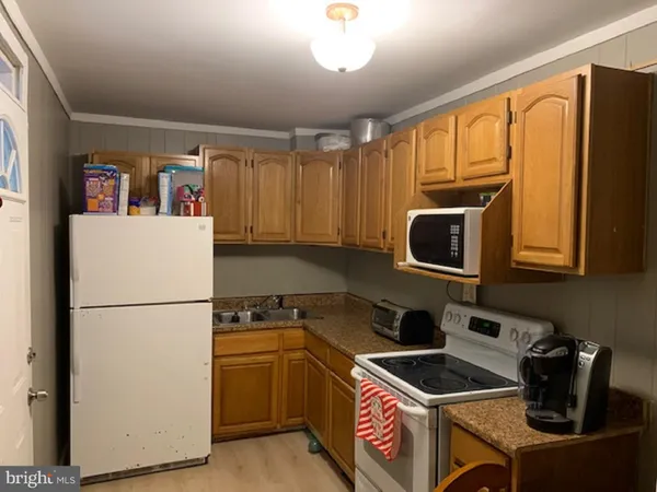 a kitchen with stainless steel appliances granite countertop a refrigerator stove top oven a sink and dishwasher