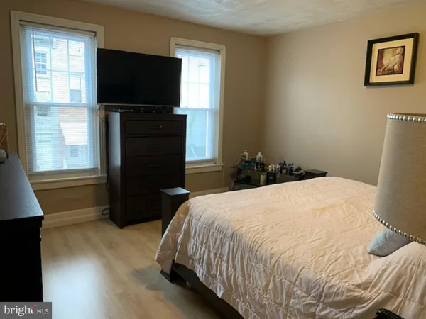 a bedroom with a bed and a flat tv screen
