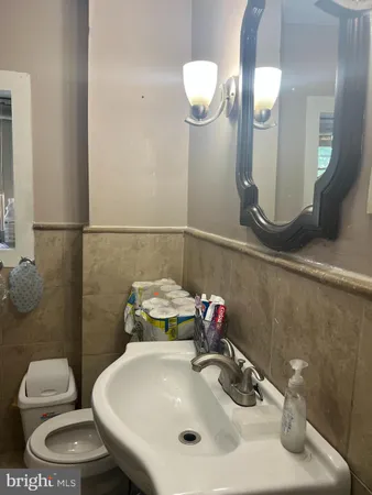 a bathroom with a sink a toilet and mirror