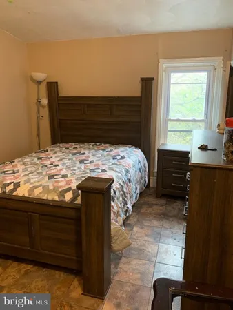 a bed sitting in a bedroom next to a window