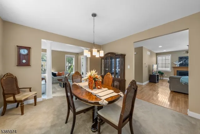 a view of a dining room with furniture and chandelier