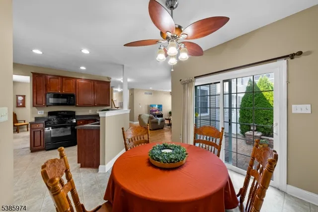 a view of a dining room with furniture a kitchen and chandelier