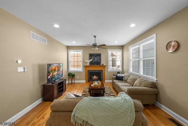 a living room with furniture fireplace and flat screen tv