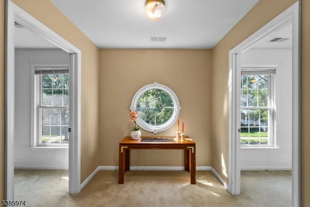 a view of workspace with window and hallway