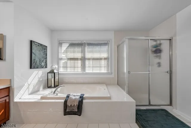 a bath tub sitting in a bathroom next to a window