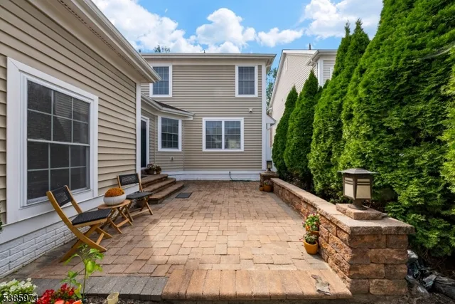 a backyard of a house with table and chairs