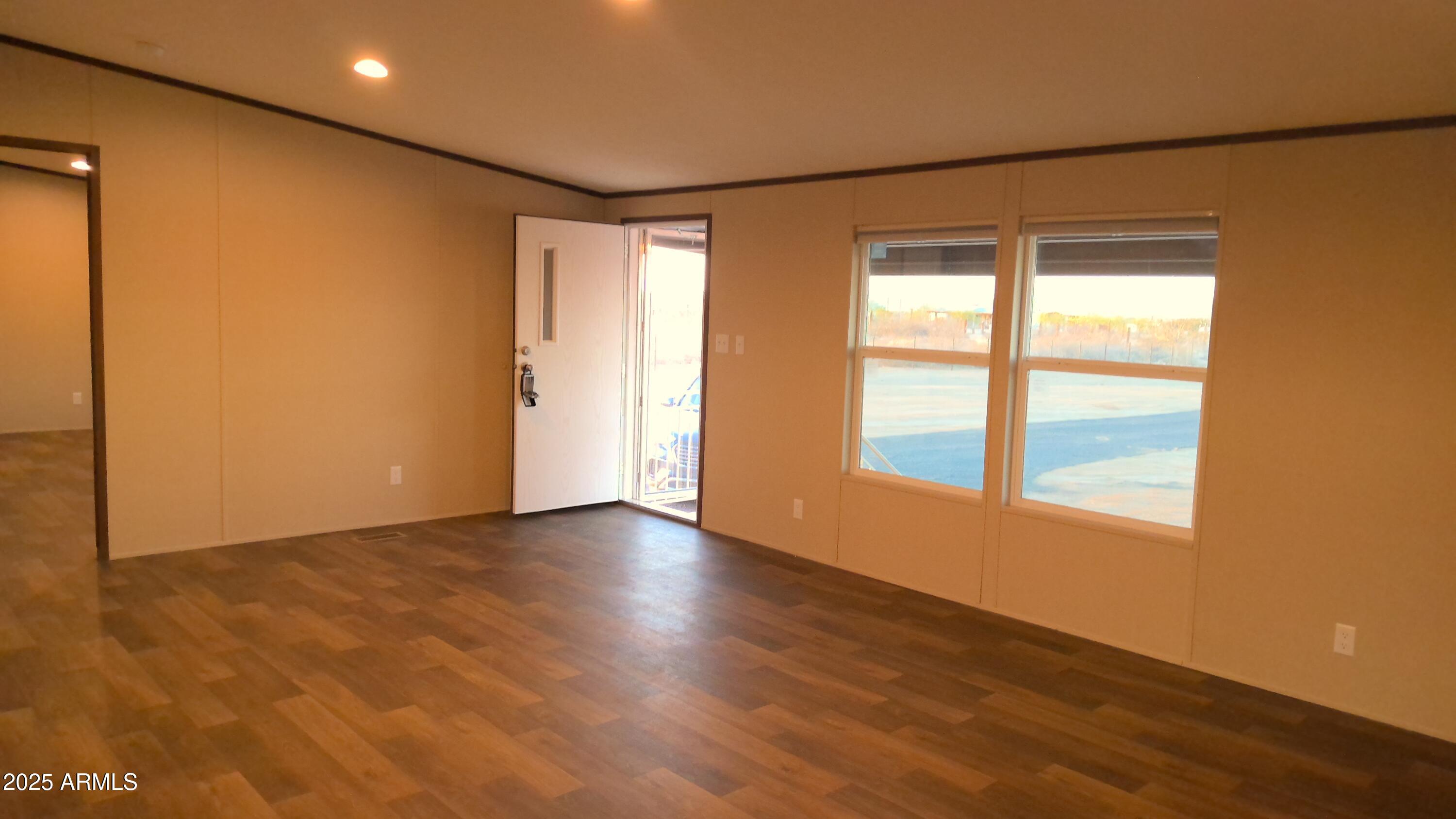 51603 West Pony Road Maricopa, AZ 85139 - Photo 13 of 36 a view of an empty room with wooden floor and a window