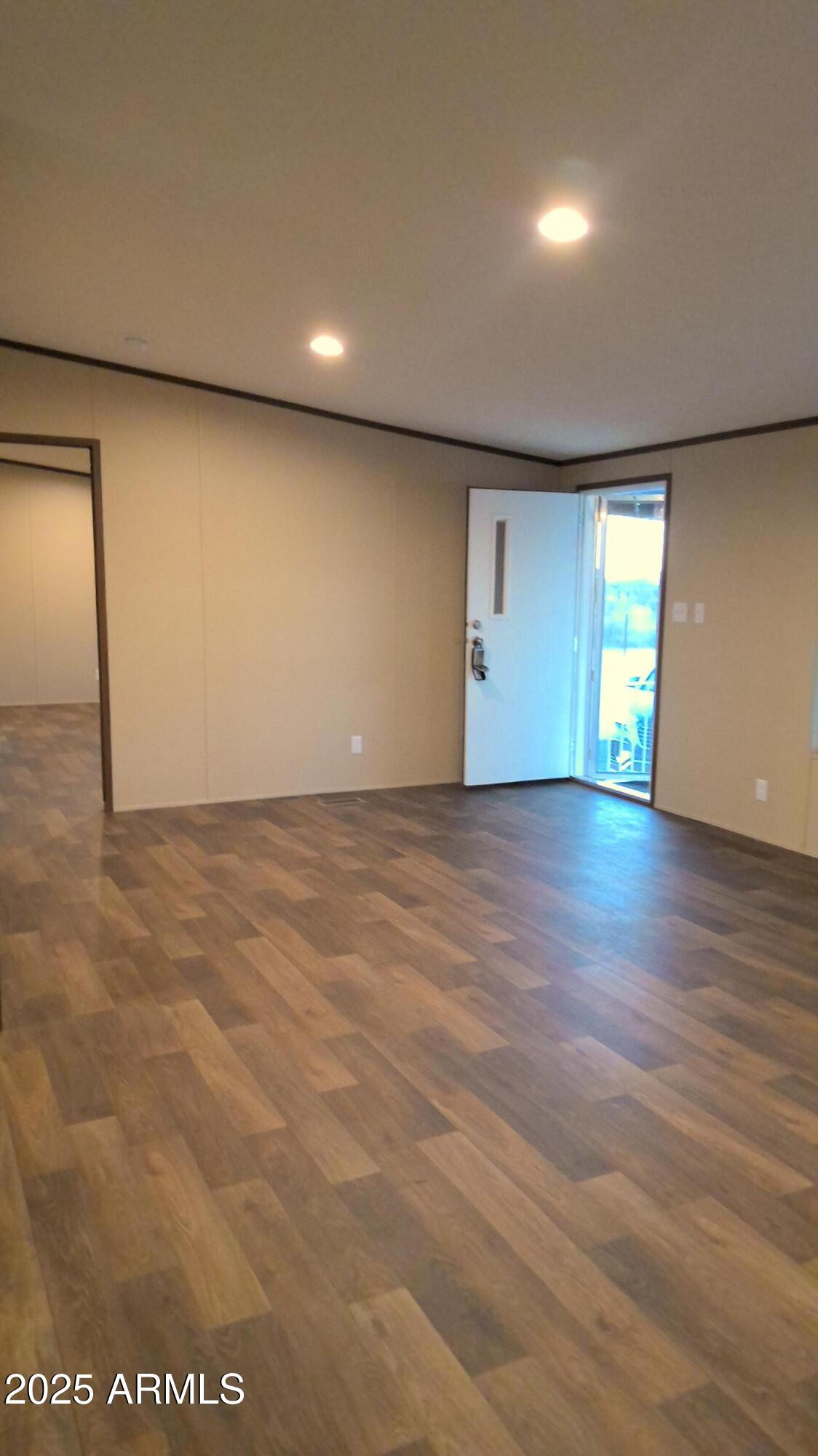 51603 West Pony Road Maricopa, AZ 85139 - Photo 14 of 36 an empty room with wooden floor and windows