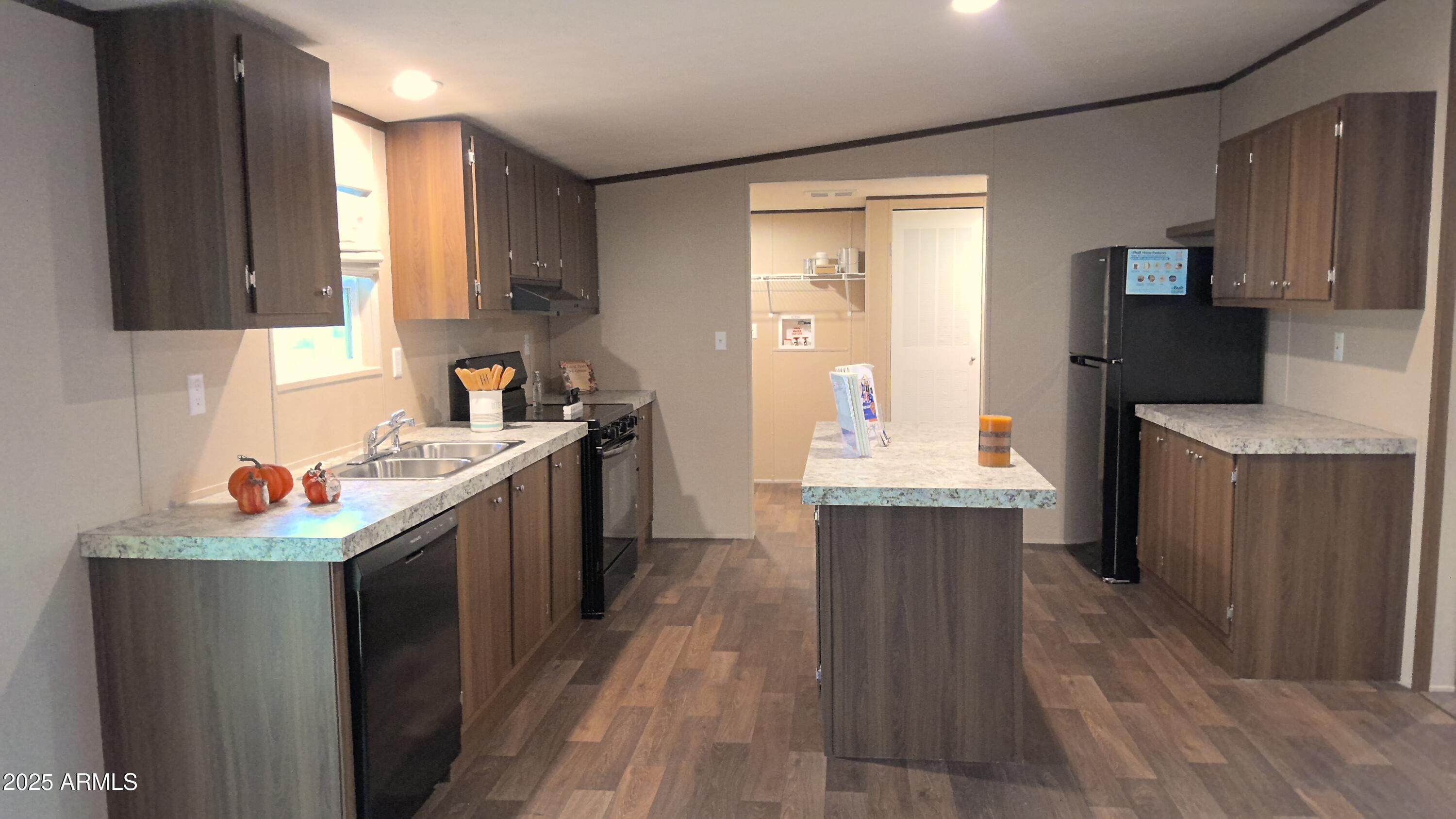 51603 West Pony Road Maricopa, AZ 85139 - Photo 15 of 36 a kitchen with a sink stove and refrigerator