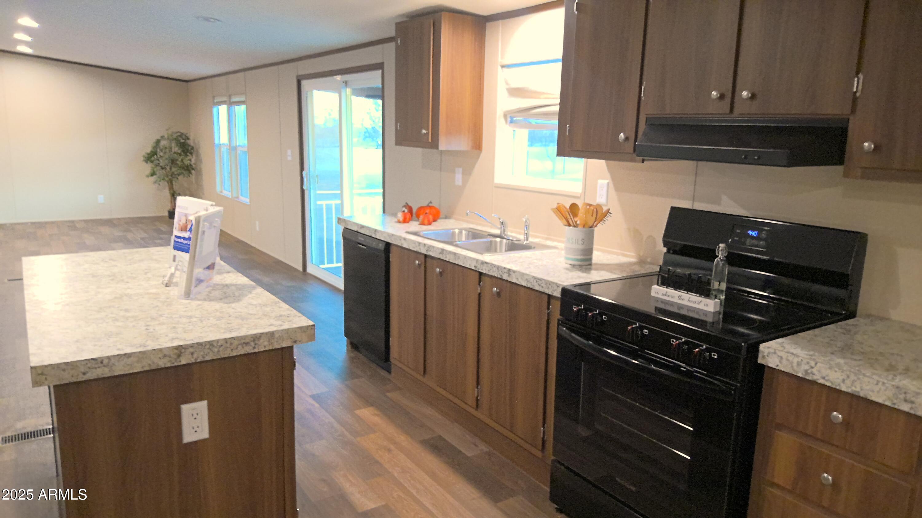 51603 West Pony Road Maricopa, AZ 85139 - Photo 18 of 36 a kitchen with stainless steel appliances granite countertop a sink stove and cabinets