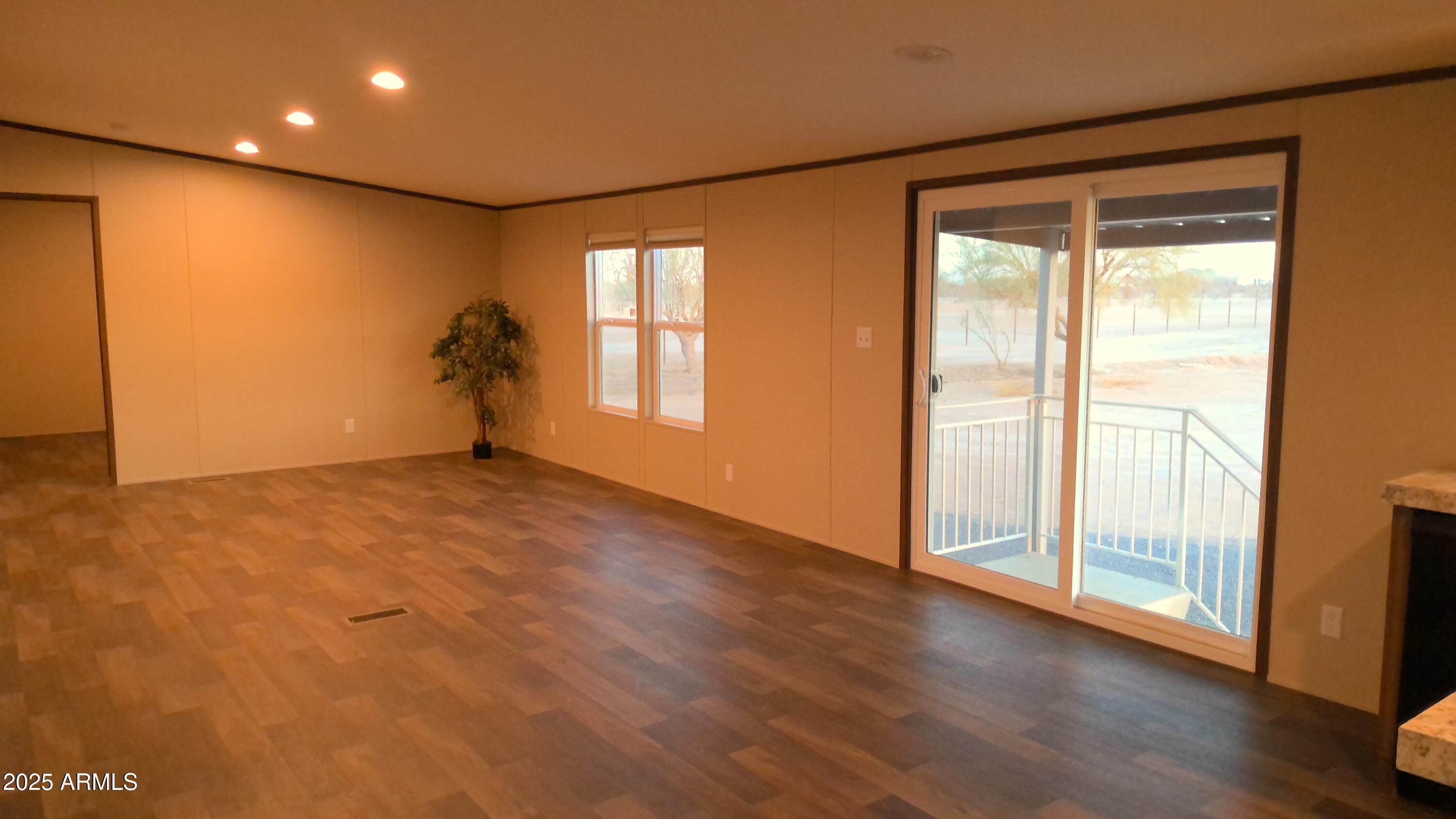 51603 West Pony Road Maricopa, AZ 85139 - Photo 22 of 36 a view of an empty room with wooden floor and a window