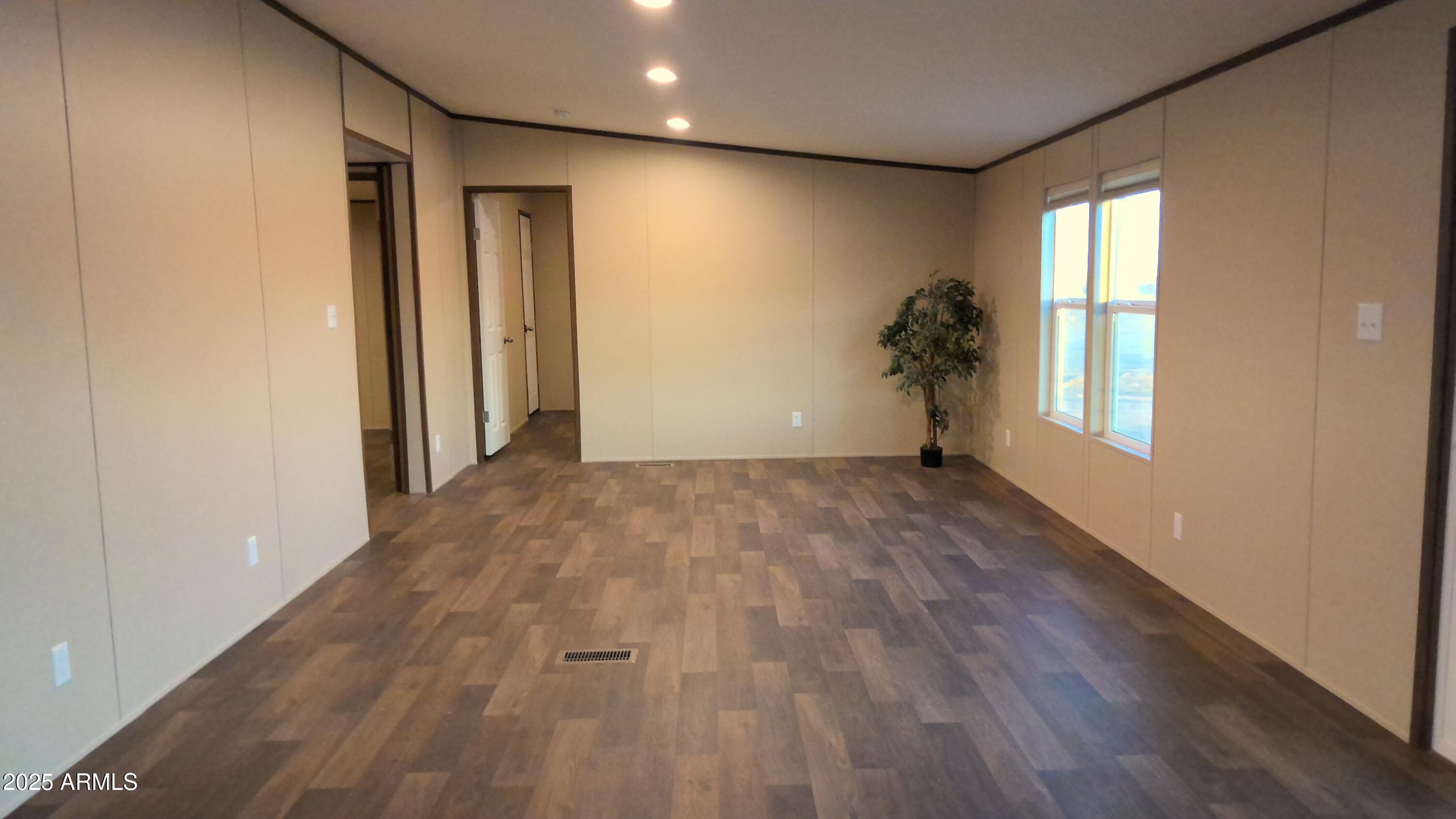 51603 West Pony Road Maricopa, AZ 85139 - Photo 23 of 36 a view of empty room with wooden floor and fan