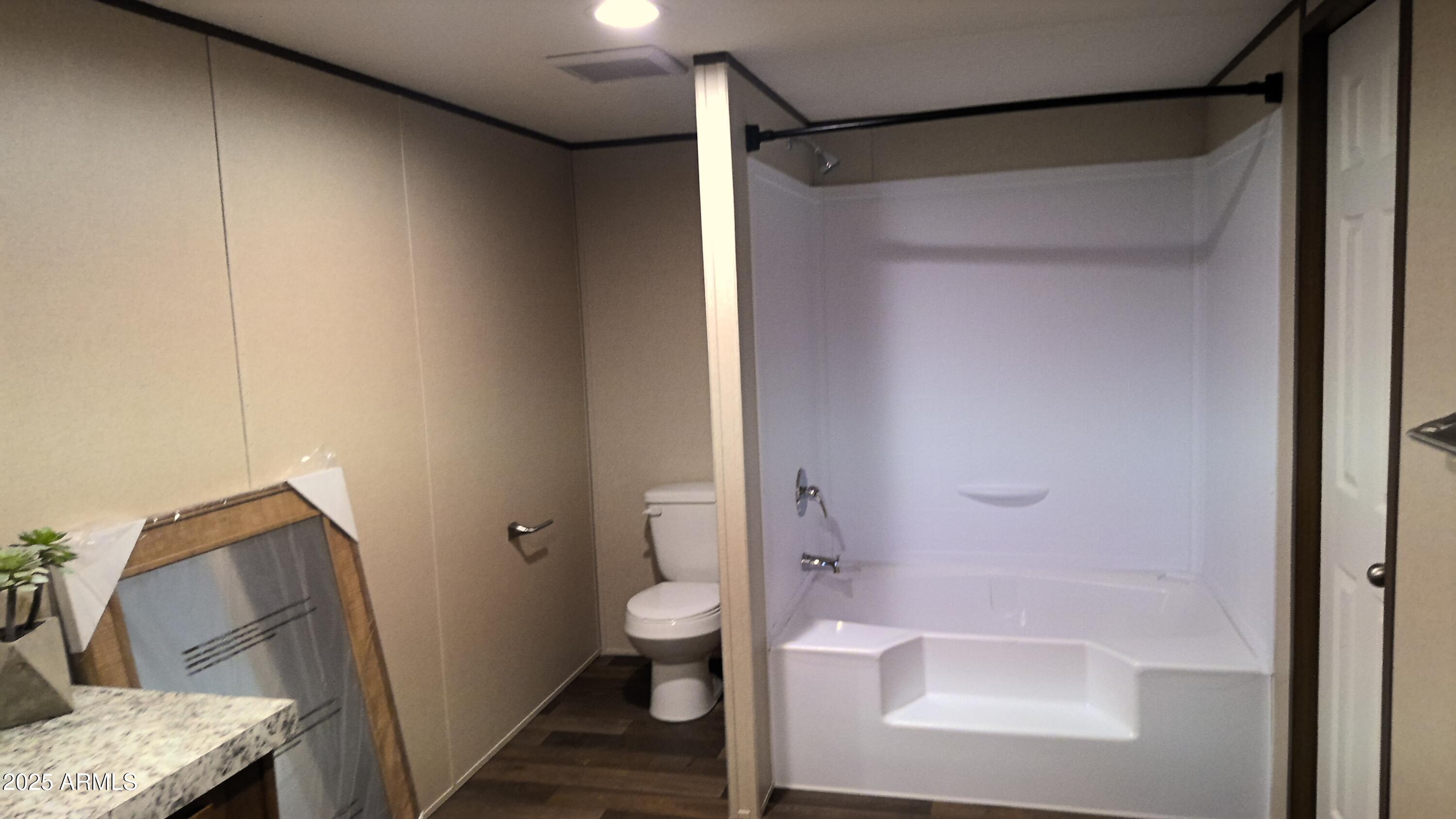 51603 West Pony Road Maricopa, AZ 85139 - Photo 26 of 36 a bathroom with a granite countertop bathtub shower sink and toilet