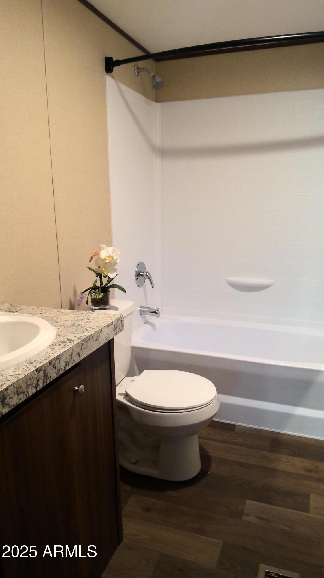 51603 West Pony Road Maricopa, AZ 85139 - Photo 34 of 36 a bathroom with a granite countertop sink toilet and shower