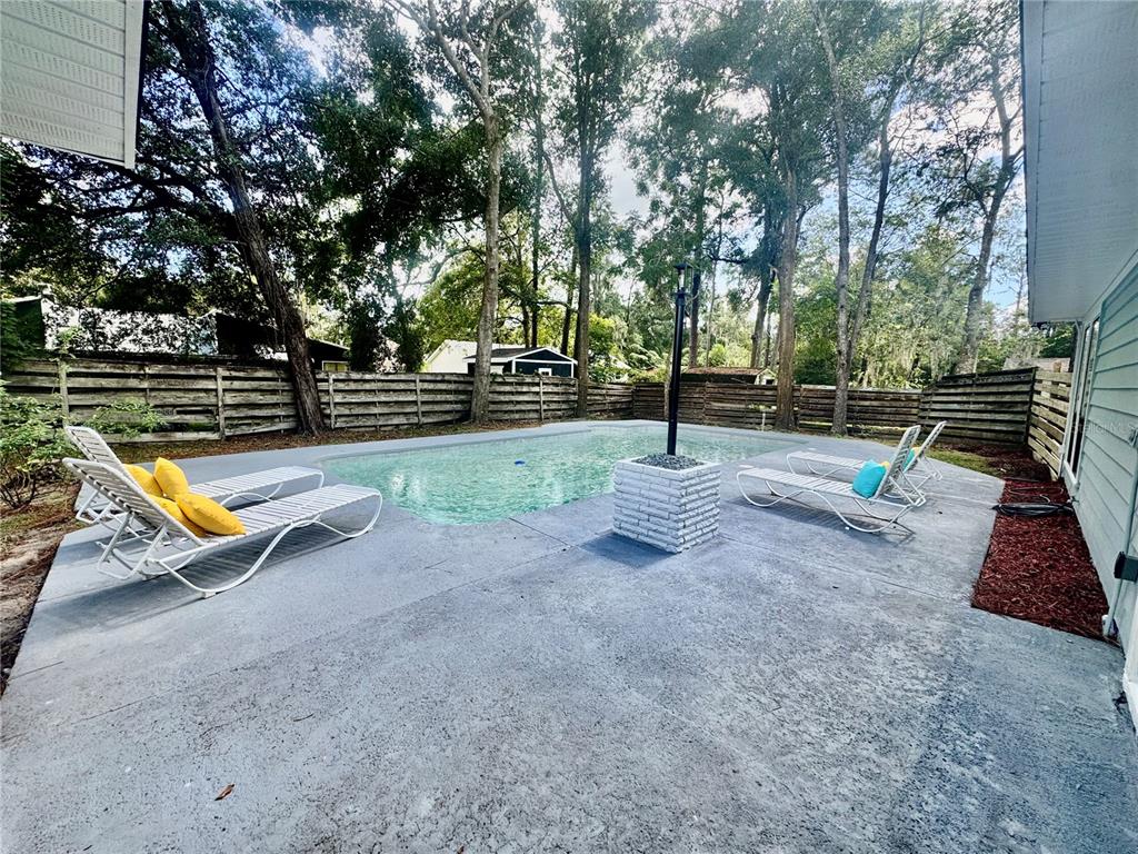 5407 Southwest 82 Terrace Gainesville, FL 32608 - Photo 2 of 31 a view of a park with swings and slides