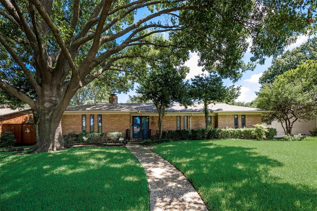 a view of house with yard and green space
