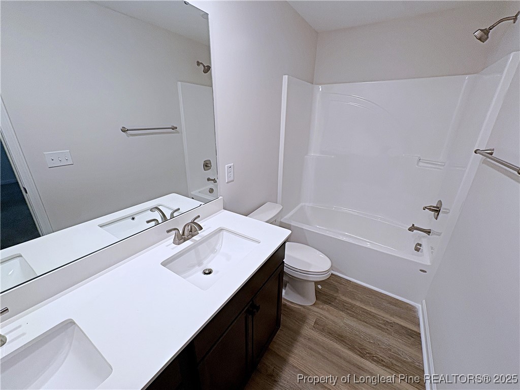 18 Morgan Court Spring Lake, NC 28390 - Photo 12 of 16 a bathroom with a sink a toilet and shower