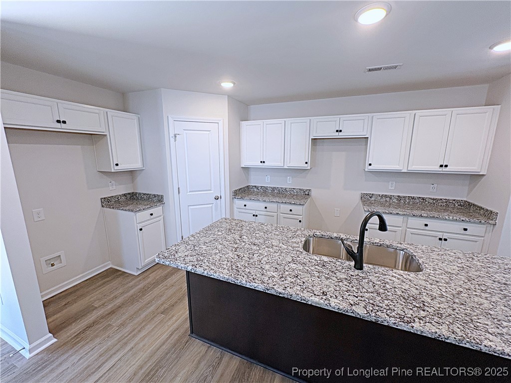 18 Morgan Court Spring Lake, NC 28390 - Photo 3 of 16 a kitchen with stainless steel appliances granite countertop a sink stove and refrigerator