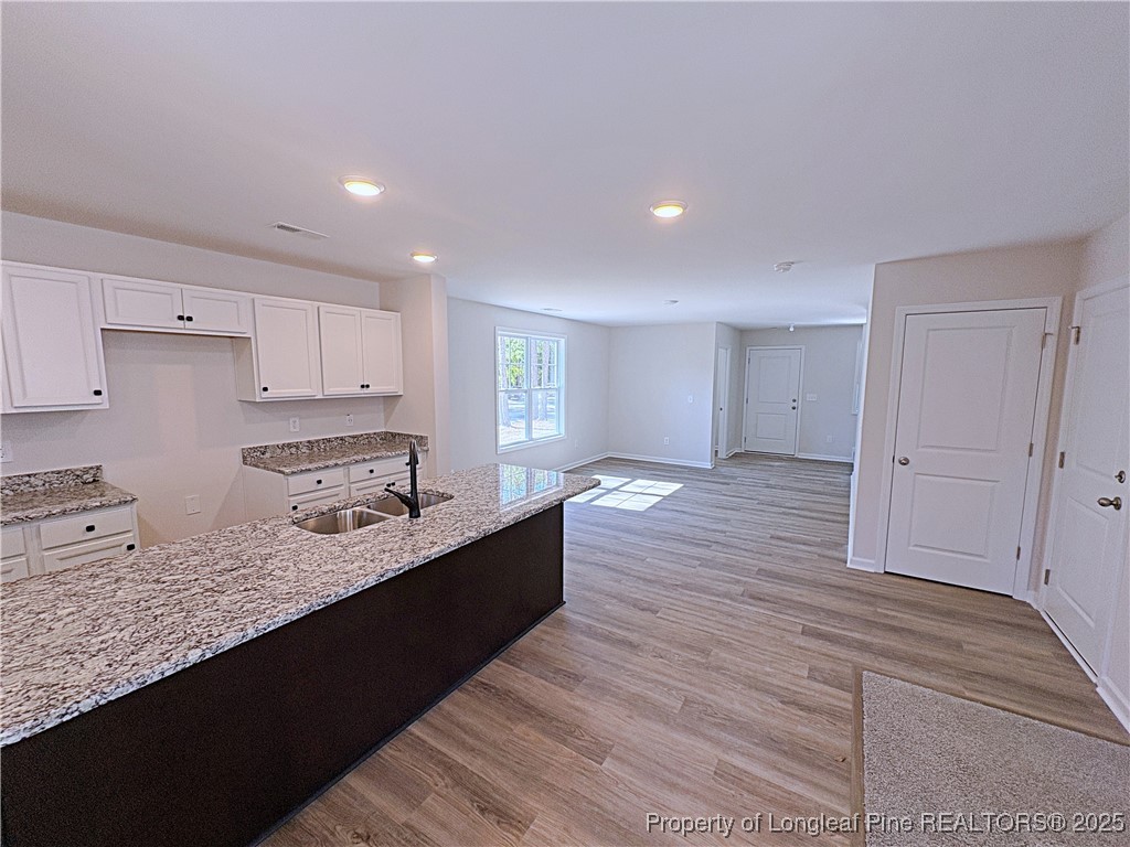 18 Morgan Court Spring Lake, NC 28390 - Photo 4 of 16 a large kitchen with kitchen island a sink stainless steel appliances and cabinets