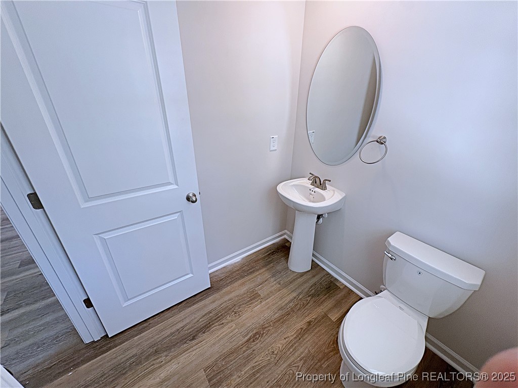 18 Morgan Court Spring Lake, NC 28390 - Photo 7 of 16 a bathroom with a toilet a sink and a mirror