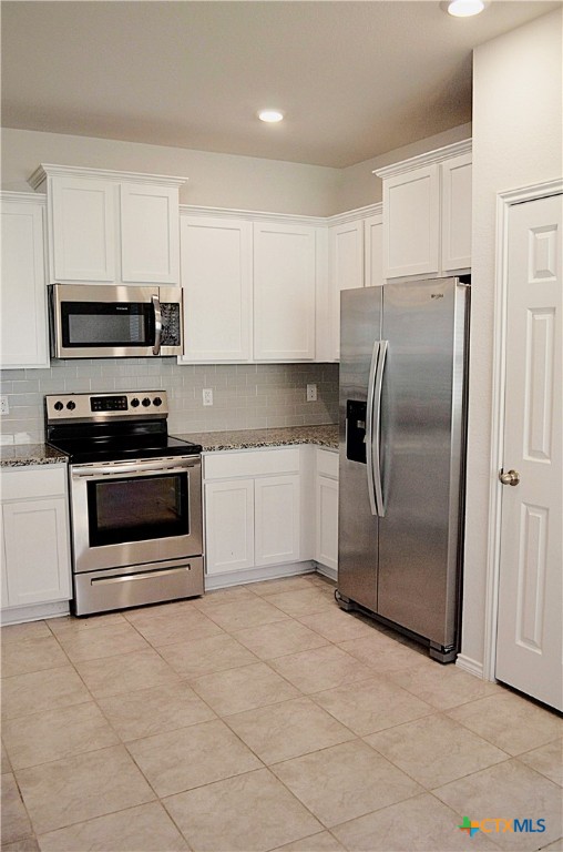 2606 Cortona Street Harker Heights, TX 76548 - Photo 11 of 40 a kitchen with stainless steel appliances granite countertop a refrigerator and a stove top oven