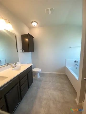 a bathroom with a toilet a sink and mirror