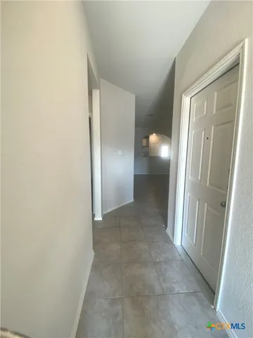 an empty room with wooden floor and mirror