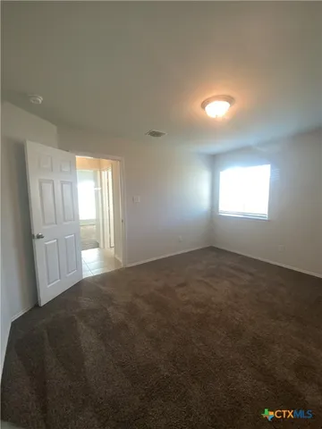 en empty room with windows and closet