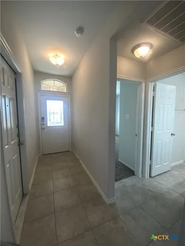 a view of an empty room and a window