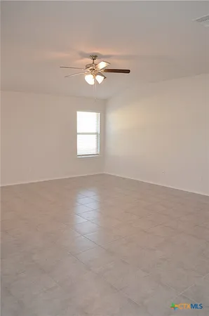 a view of a livingroom with a ceiling fan and window