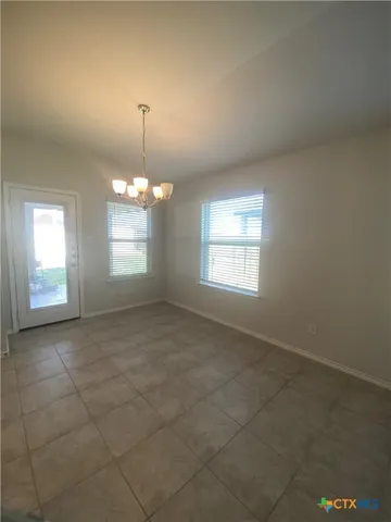 a large kitchen with a large counter top stainless steel appliances and cabinets