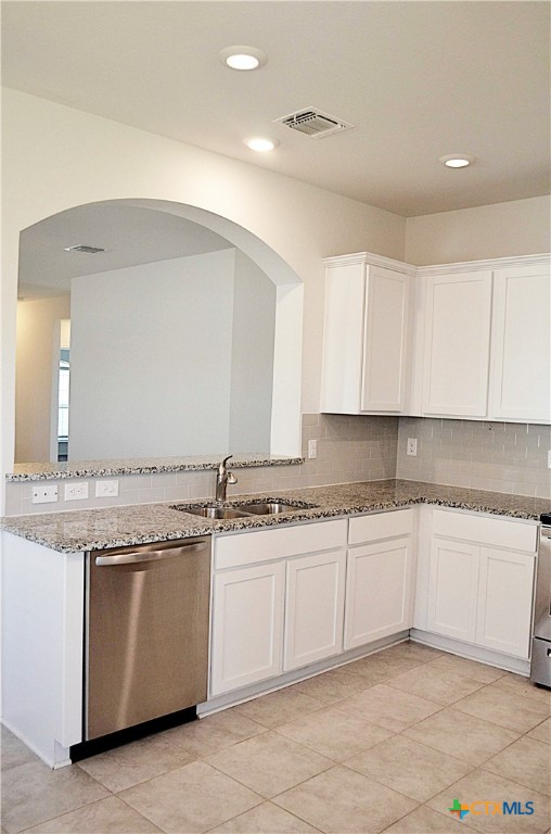 2606 Cortona Street Harker Heights, TX 76548 - Photo 10 of 40 a kitchen with granite countertop a sink and white cabinets