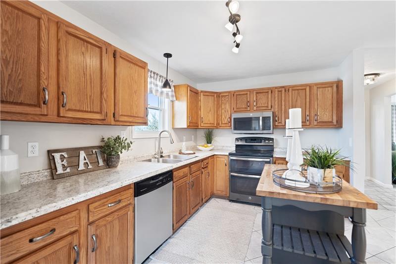 163 Upper Service Road Hookstown, PA 15050 - Photo 7 of 41 a kitchen with stainless steel appliances granite countertop a stove refrigerator and cabinets