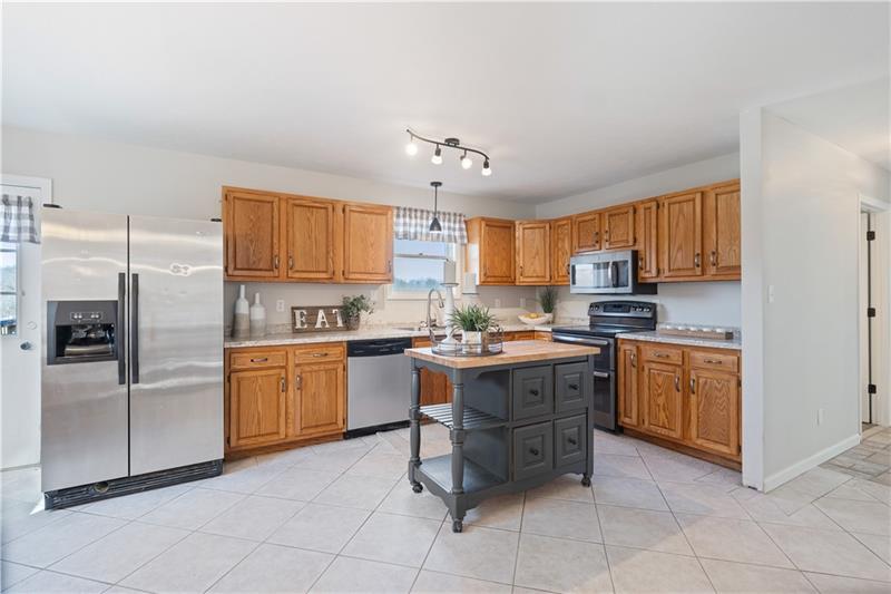 163 Upper Service Road Hookstown, PA 15050 - Photo 10 of 41 a kitchen with granite countertop stainless steel appliances a sink and cabinets