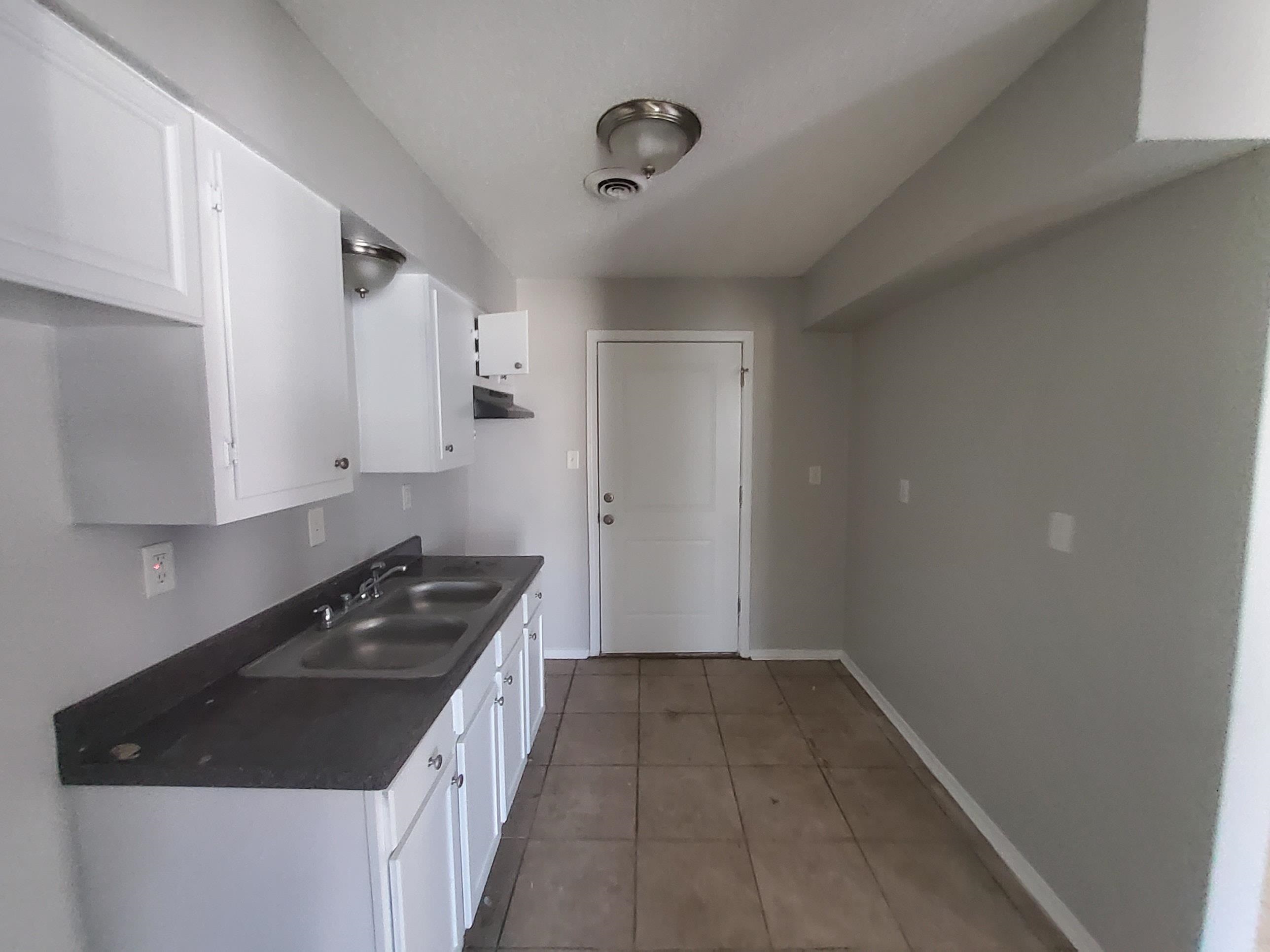 3693 Windermere Road Memphis, TN 38128 - Photo 5 of 10 a kitchen with a sink stove and cabinets