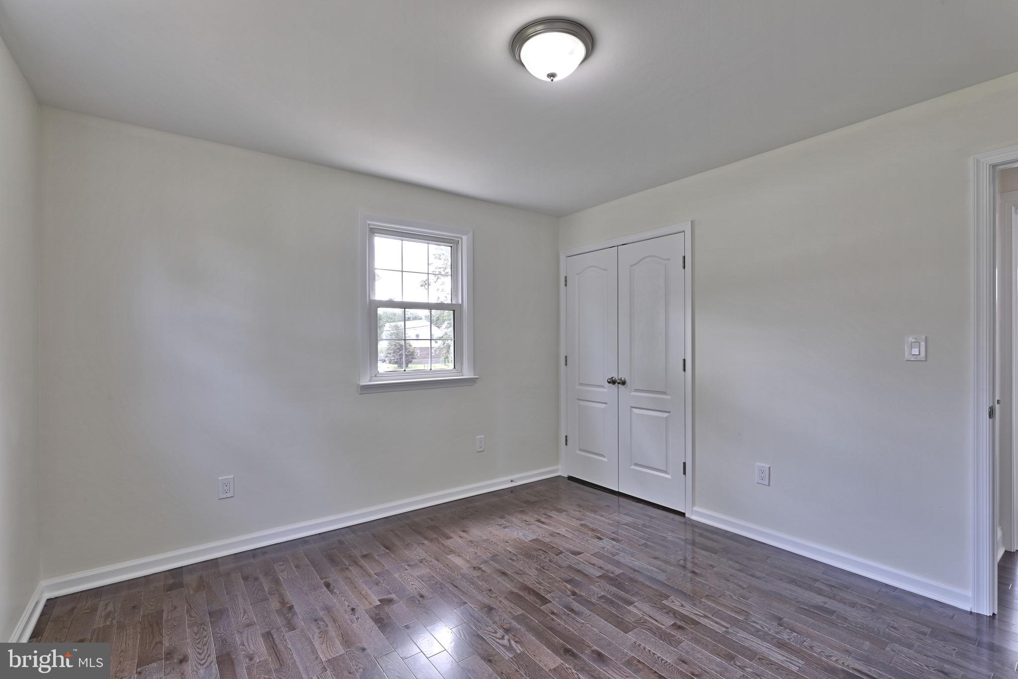 620 Arndt Avenue Riverside, NJ 08075 - Photo 13 of 22 an empty room with wooden floor and windows