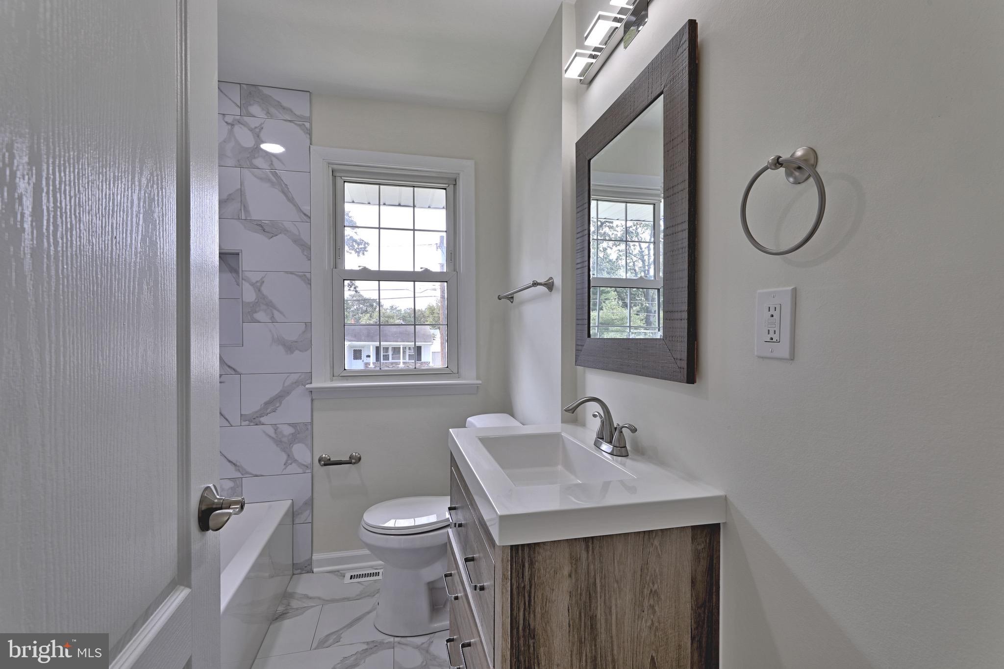 620 Arndt Avenue Riverside, NJ 08075 - Photo 16 of 22 a bathroom with a sink a toilet and a mirror